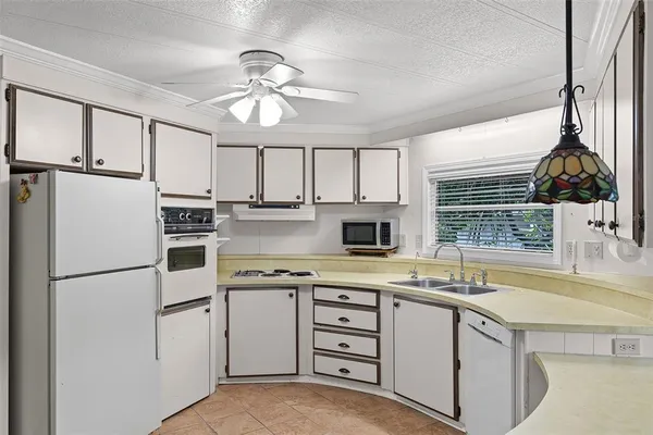 a kitchen with a stove a sink and a microwave