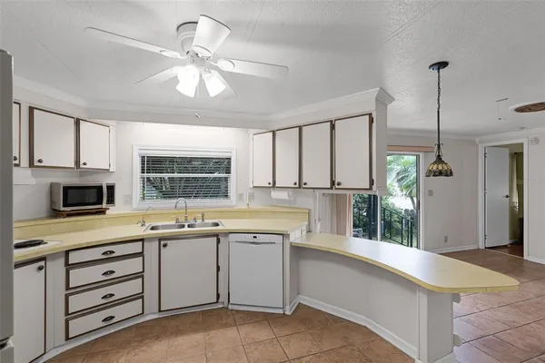 a kitchen with granite countertop a stove top oven sink and cabinets
