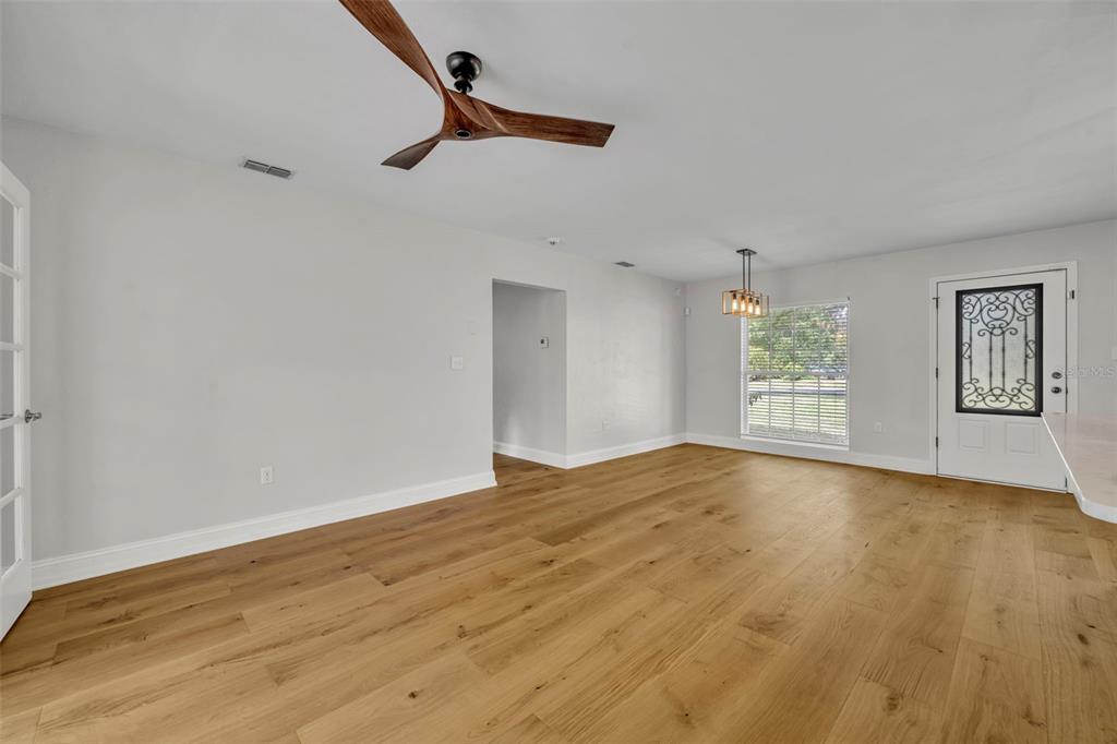 4234 Kendrick Road Orlando, FL 32804 - Photo 10 of 46 a view of empty room with wooden floor and window