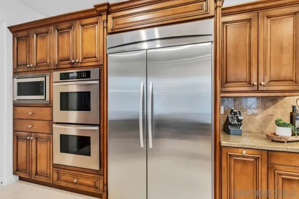 a kitchen with stainless steel appliances granite countertop a refrigerator and cabinets