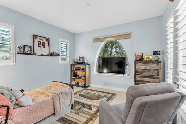 a bedroom with a bed and a flat screen tv