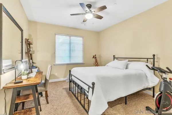 a bedroom with a large bed and a chandelier