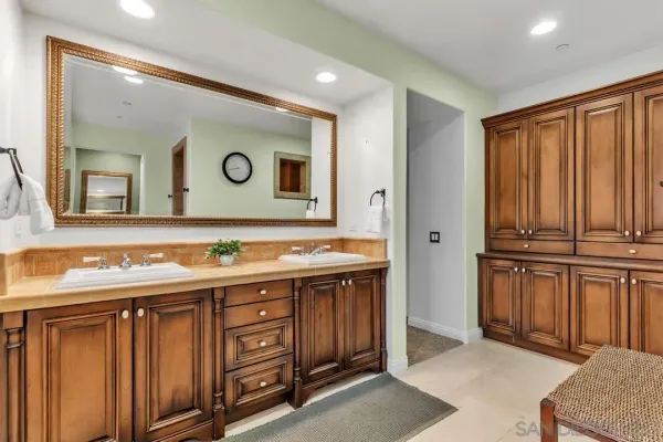 a bathroom with a double vanity sink and a mirror