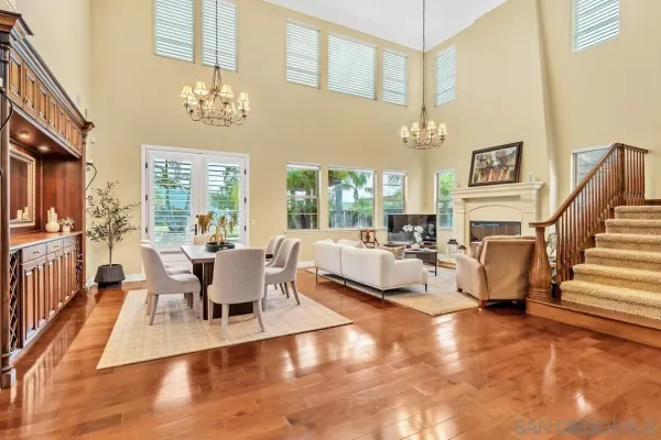 a living room with fireplace furniture and a chandelier