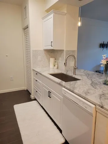 a kitchen with a sink and a refrigerator