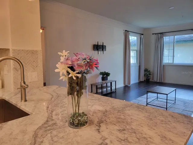 a view of a small space with wooden floor and a window