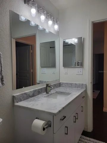 a bathroom with a shower and a sink