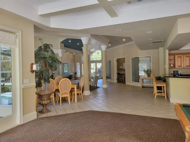 a living room with furniture and flowers