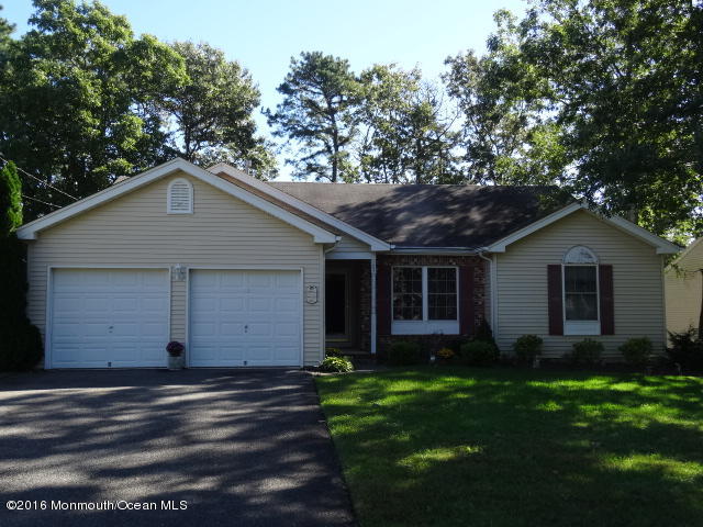 109 Castaway Road Manahawkin, NJ 08050 - Photo 1 of 25 a front view of house with yard and trees in the background