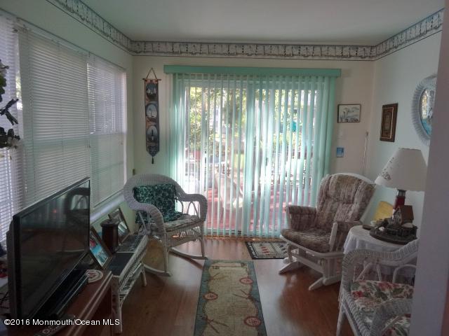 109 Castaway Road Manahawkin, NJ 08050 - Photo 11 of 25 a living room with furniture and a large window