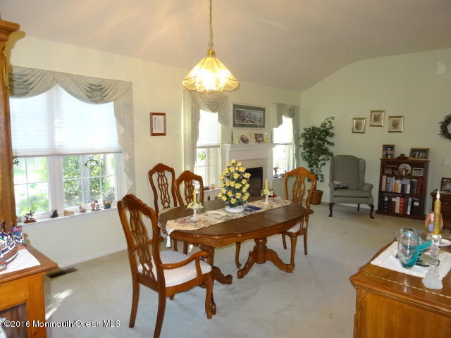 109 Castaway Road Manahawkin, NJ 08050 - Photo 13 of 25 a view of a dining room with furniture and chandelier