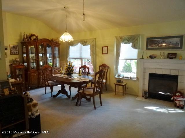 109 Castaway Road Manahawkin, NJ 08050 - Photo 14 of 25 a view of a livingroom with furniture and a fireplace