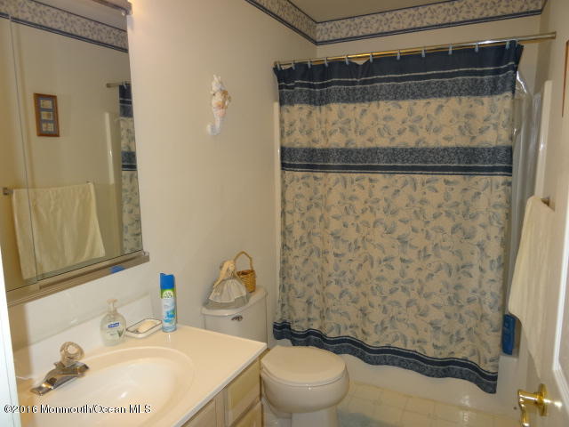 109 Castaway Road Manahawkin, NJ 08050 - Photo 20 of 25 a bathroom with a sink toilet and shower