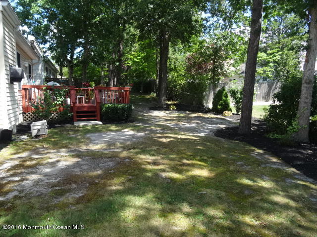 109 Castaway Road Manahawkin, NJ 08050 - Photo 23 of 25 a view of a yard with large trees and plants