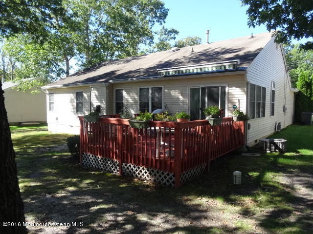 109 Castaway Road Manahawkin, NJ 08050 - Photo 25 of 25 a view of a house with a wooden deck front of house