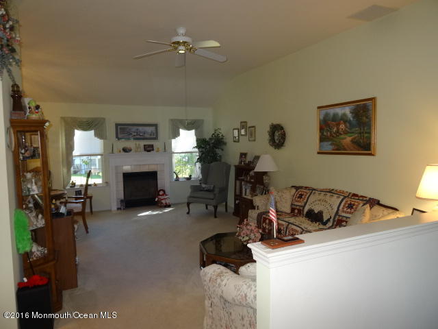 109 Castaway Road Manahawkin, NJ 08050 - Photo 4 of 25 a living room with furniture and a fireplace