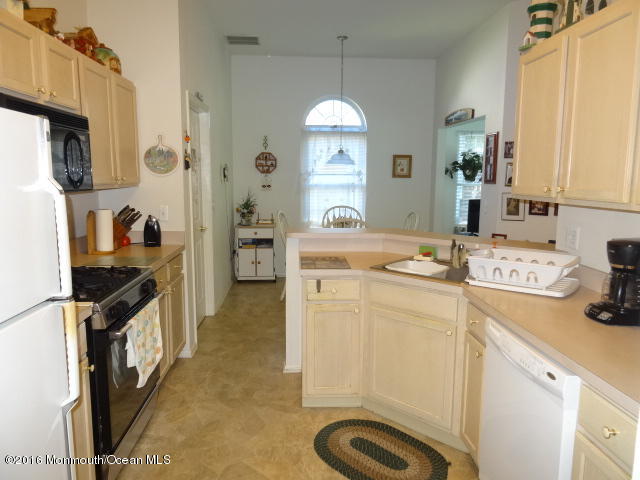 109 Castaway Road Manahawkin, NJ 08050 - Photo 7 of 25 a kitchen with a sink stove and refrigerator