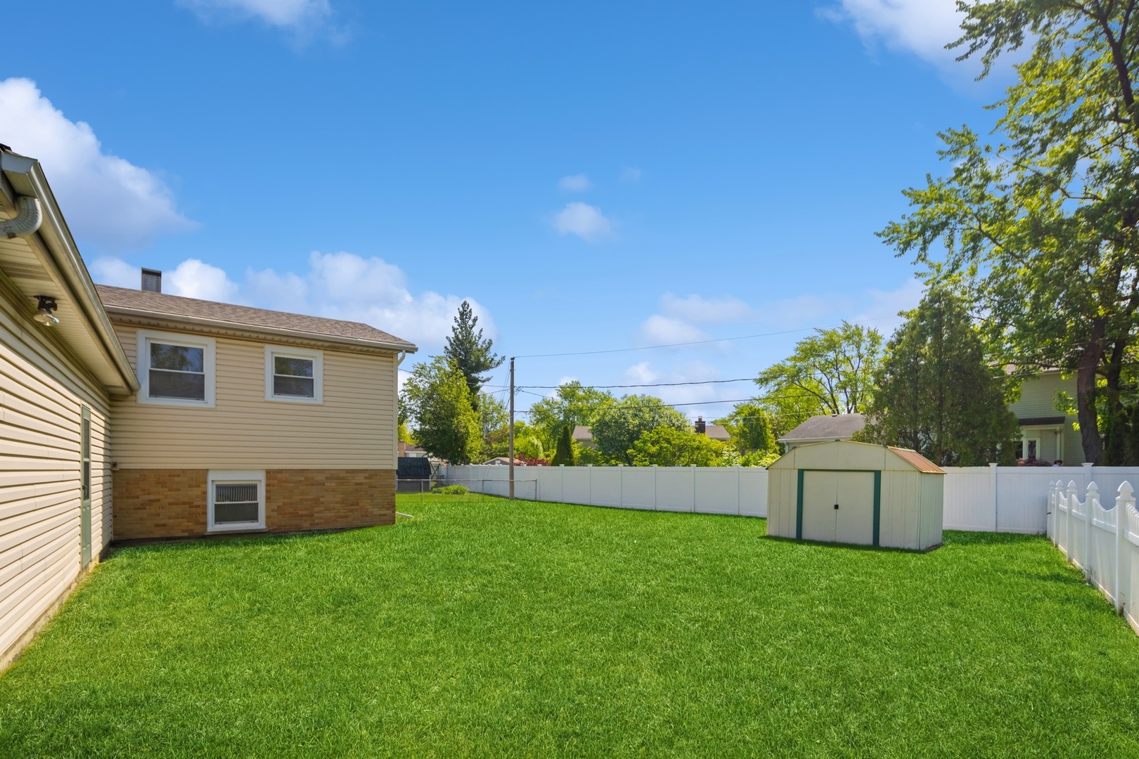 1025 Timber Lane Darien, IL 60561 - Photo 16 of 17 a backyard of a house with lots of green space and plants