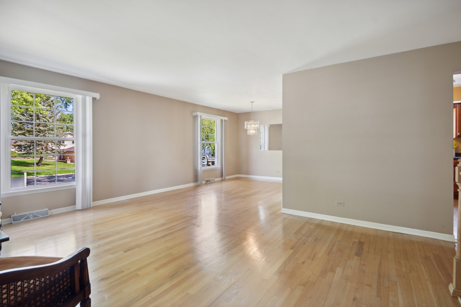 1025 Timber Lane Darien, IL 60561 - Photo 2 of 17 a view of an empty room with wooden floor and a window