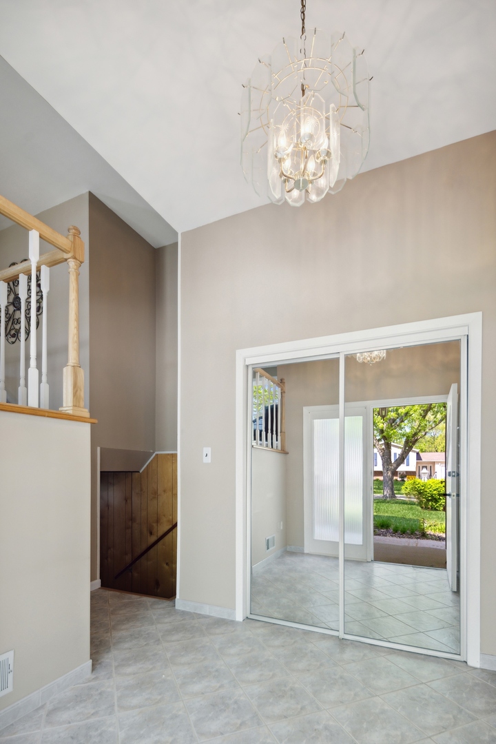 1025 Timber Lane Darien, IL 60561 - Photo 5 of 17 a view of a hallway with chandelier and entryway