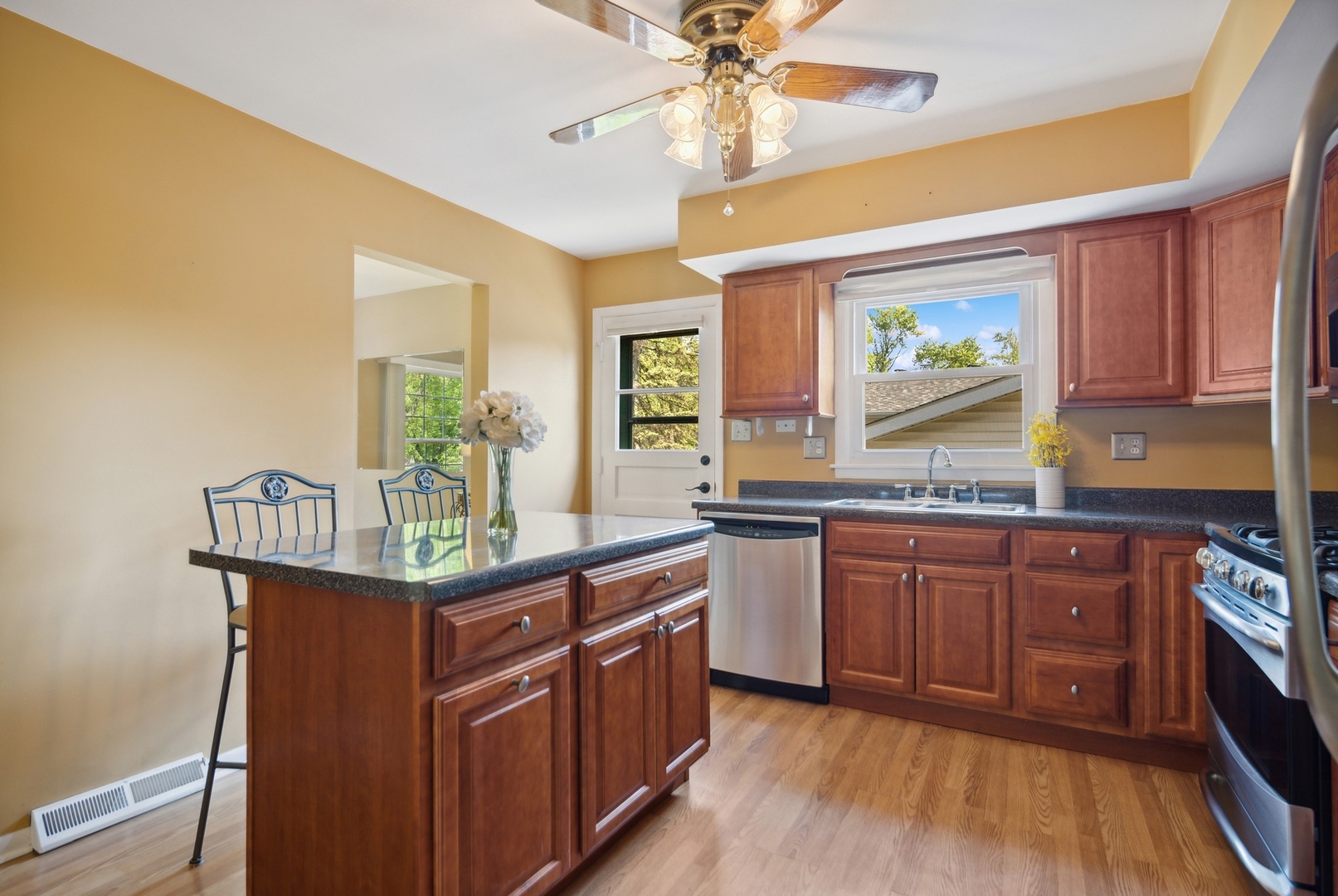 1025 Timber Lane Darien, IL 60561 - Photo 7 of 17 a kitchen with stainless steel appliances granite countertop a sink and wooden cabinets