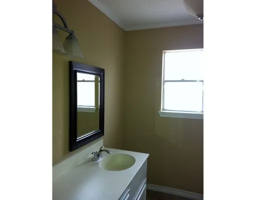 a bathroom with a sink and mirror