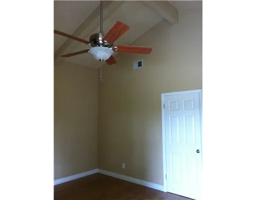 a small space with a fan and a window