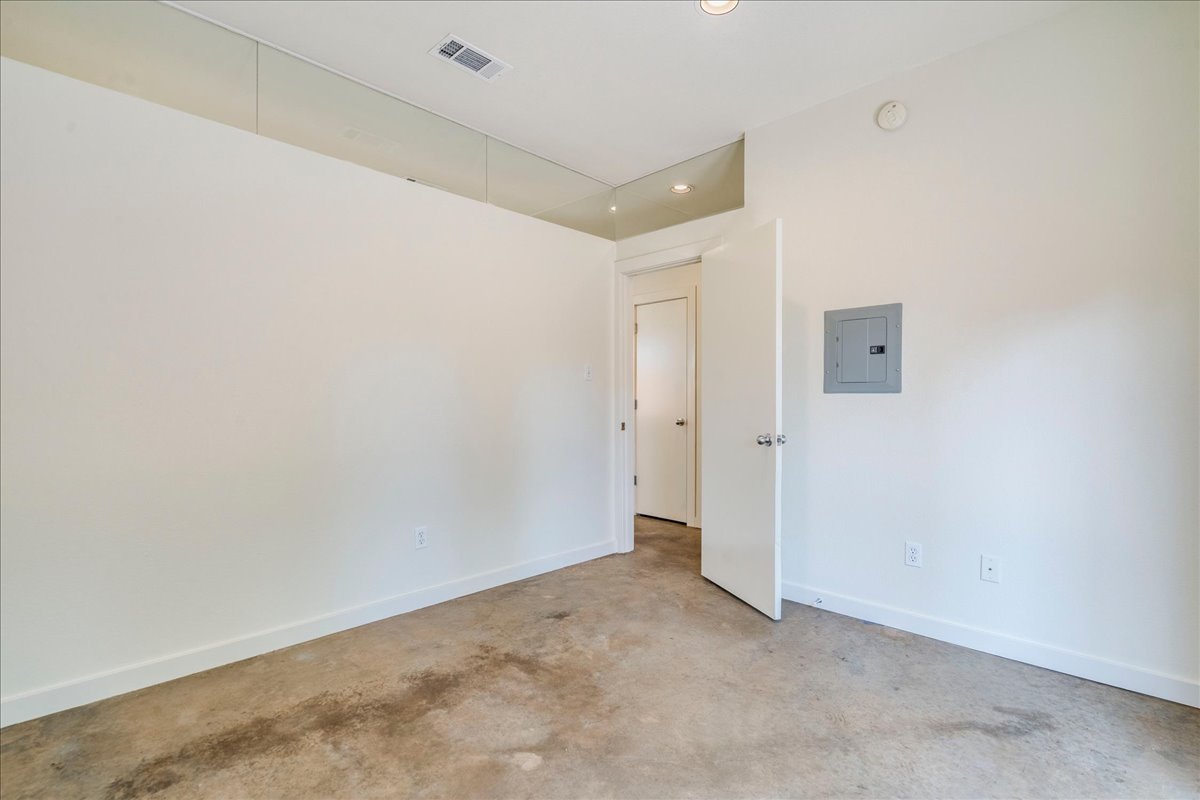2811 Hardeman Street, Unit B Austin, TX 78704 - Photo 13 of 34 Polished concrete floors and high ceilings with upper glass panels define this modern interior.