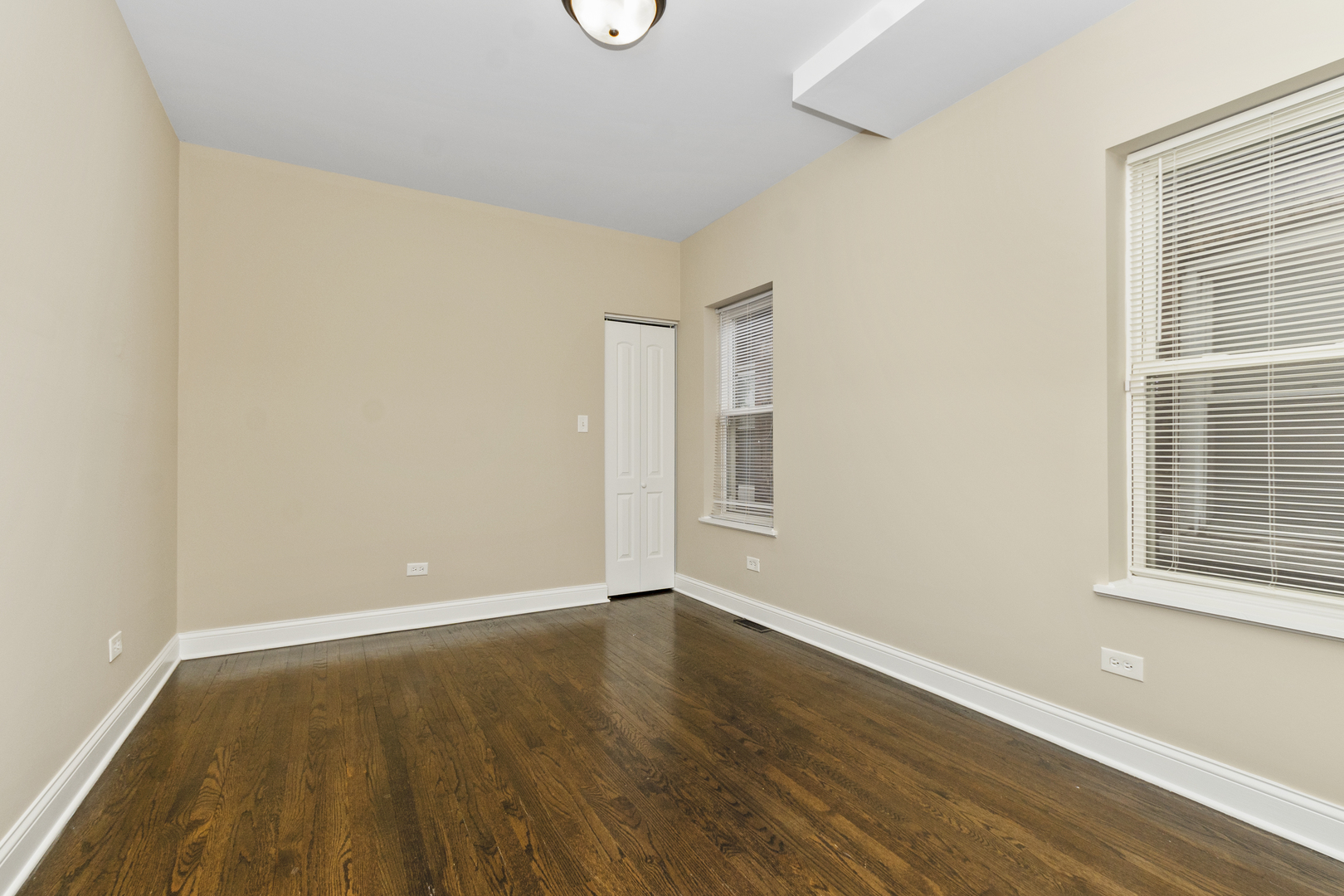 8317 South Merrill Avenue Chicago, IL 60617 - Photo 11 of 23 an empty room with wooden floor and windows
