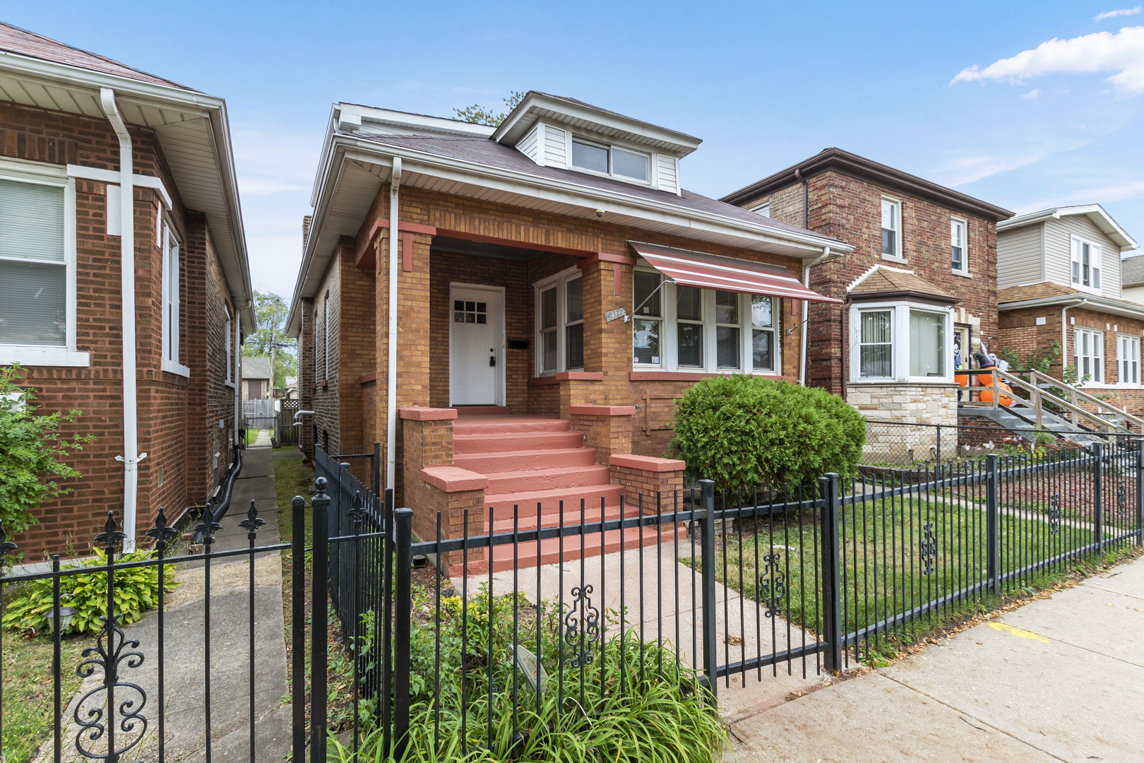 8317 South Merrill Avenue Chicago, IL 60617 - Photo 2 of 23 a front view of house with yard and green space