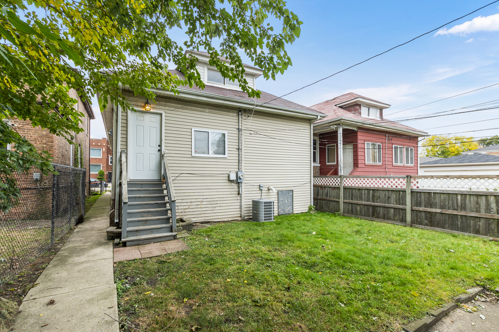 8317 South Merrill Avenue Chicago, IL 60617 - Photo 22 of 23 a front view of a house with a yard