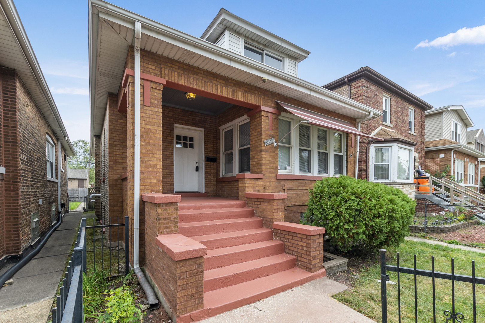 8317 South Merrill Avenue Chicago, IL 60617 - Photo 23 of 23 a front view of a house with garden