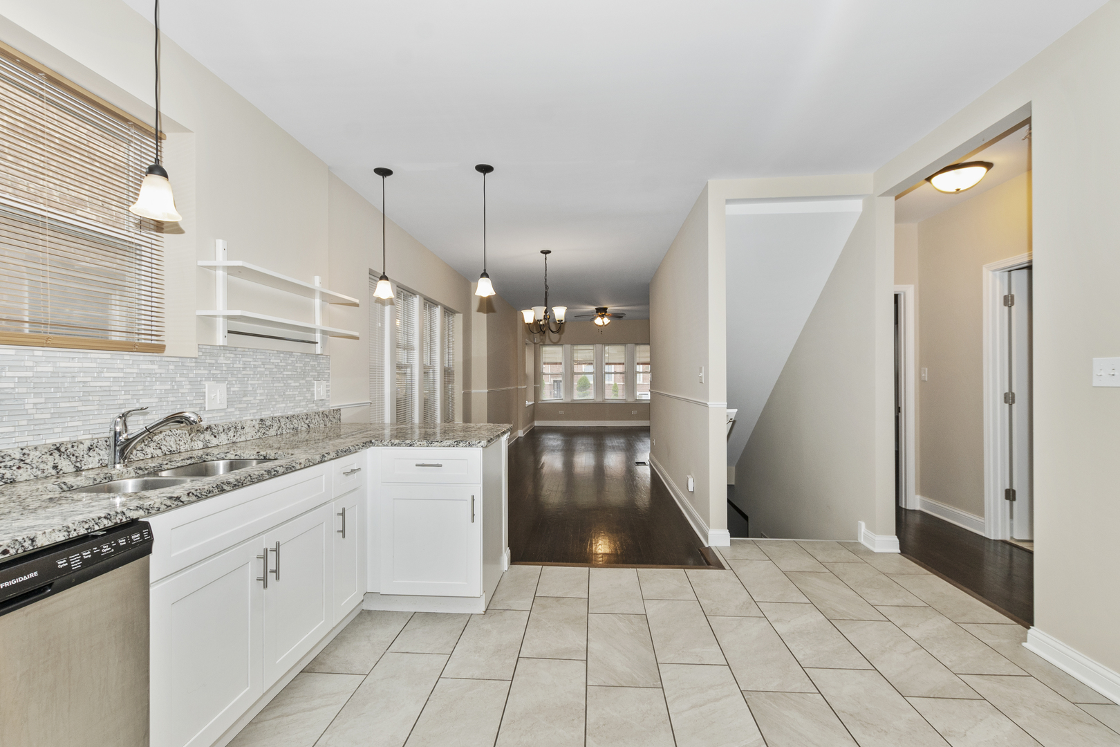 8317 South Merrill Avenue Chicago, IL 60617 - Photo 8 of 23 a kitchen with a sink a stove a refrigerator and white cabinets