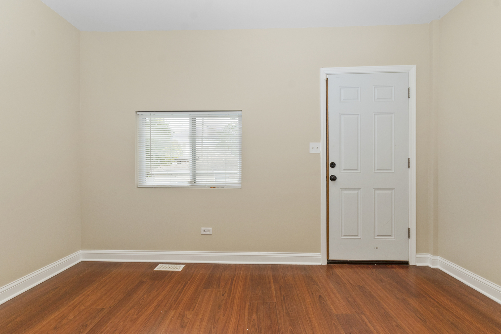 8317 South Merrill Avenue Chicago, IL 60617 - Photo 9 of 23 an empty room with wooden floor and windows