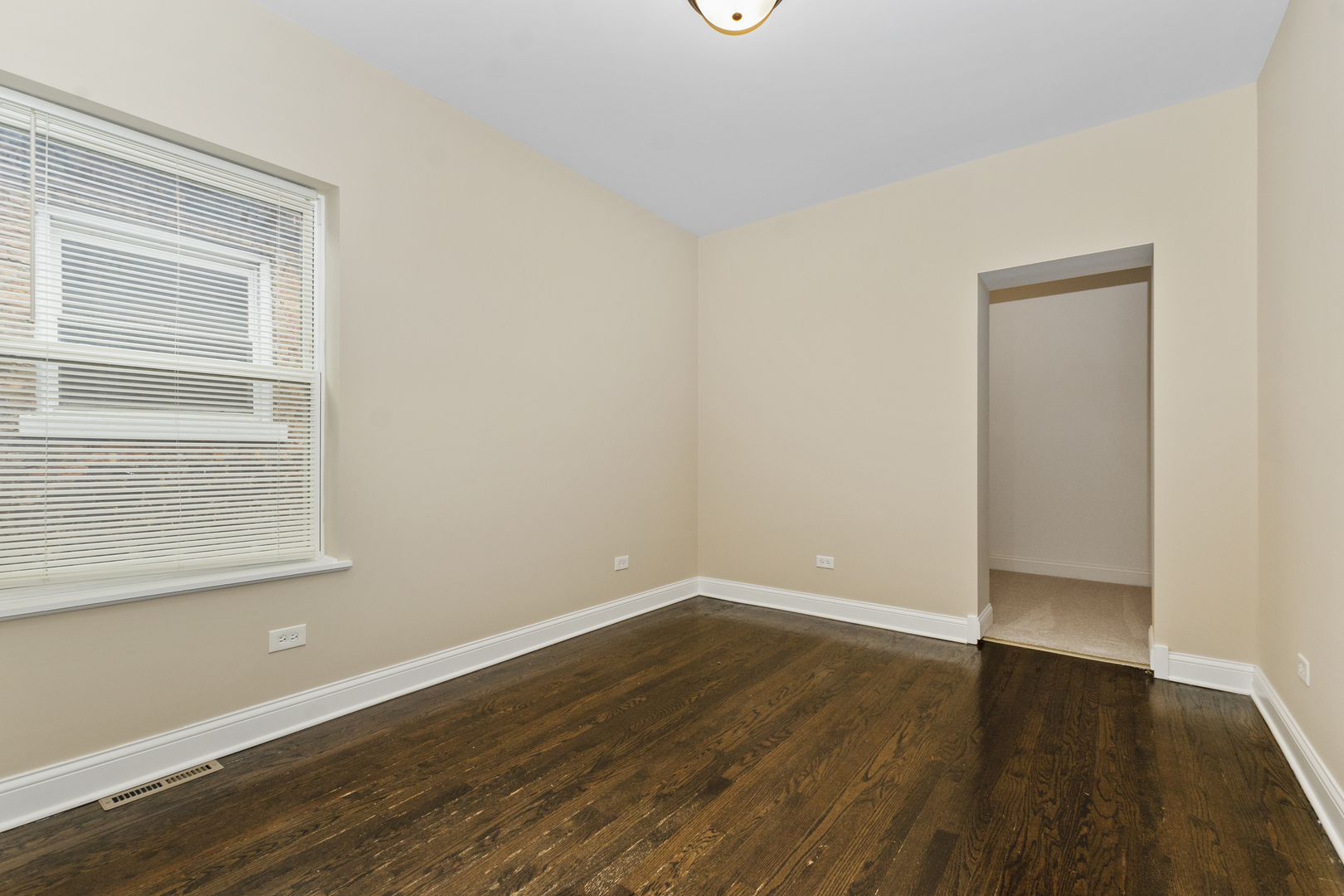 8317 South Merrill Avenue Chicago, IL 60617 - Photo 10 of 23 an empty room with wooden floor and windows