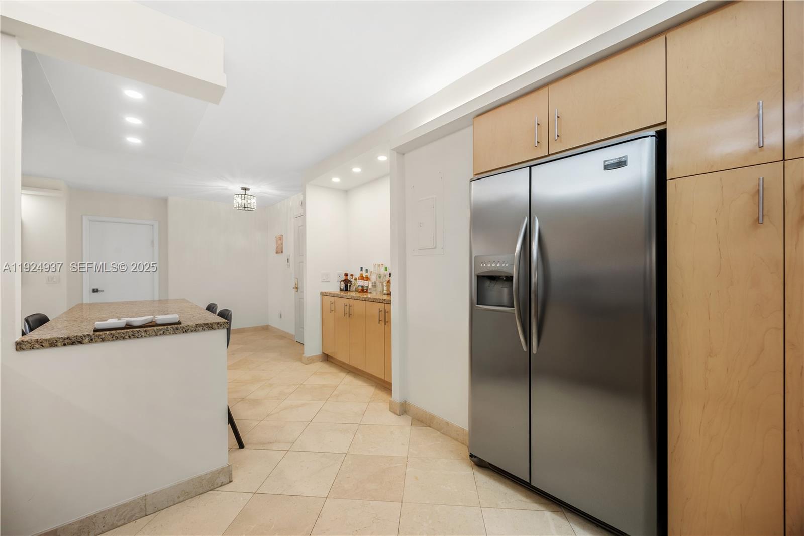 9801 Collins Avenue, Unit 10G Bal Harbour, FL 33154 - Photo 12 of 34 a kitchen with stainless steel appliances granite countertop a refrigerator a sink and a refrigerator