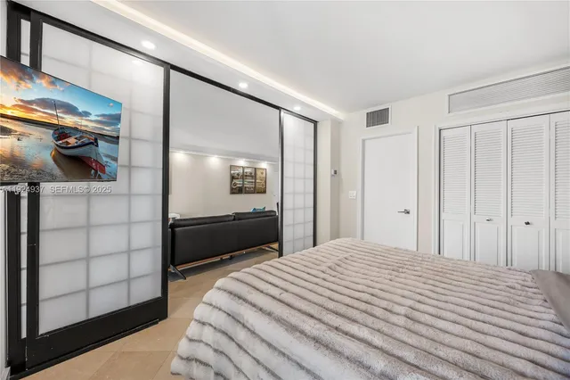 a bedroom with a bed and walk in closet