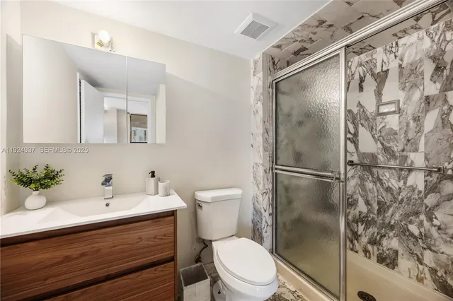 a bathroom with a sink toilet and shower