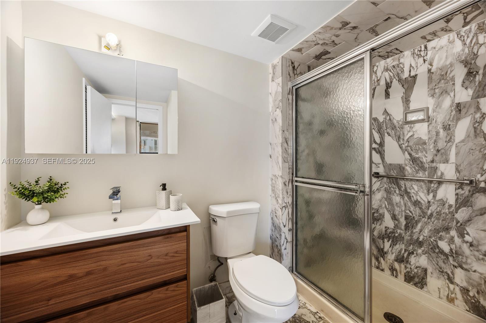 9801 Collins Avenue, Unit 10G Bal Harbour, FL 33154 - Photo 22 of 34 a bathroom with a sink toilet and shower