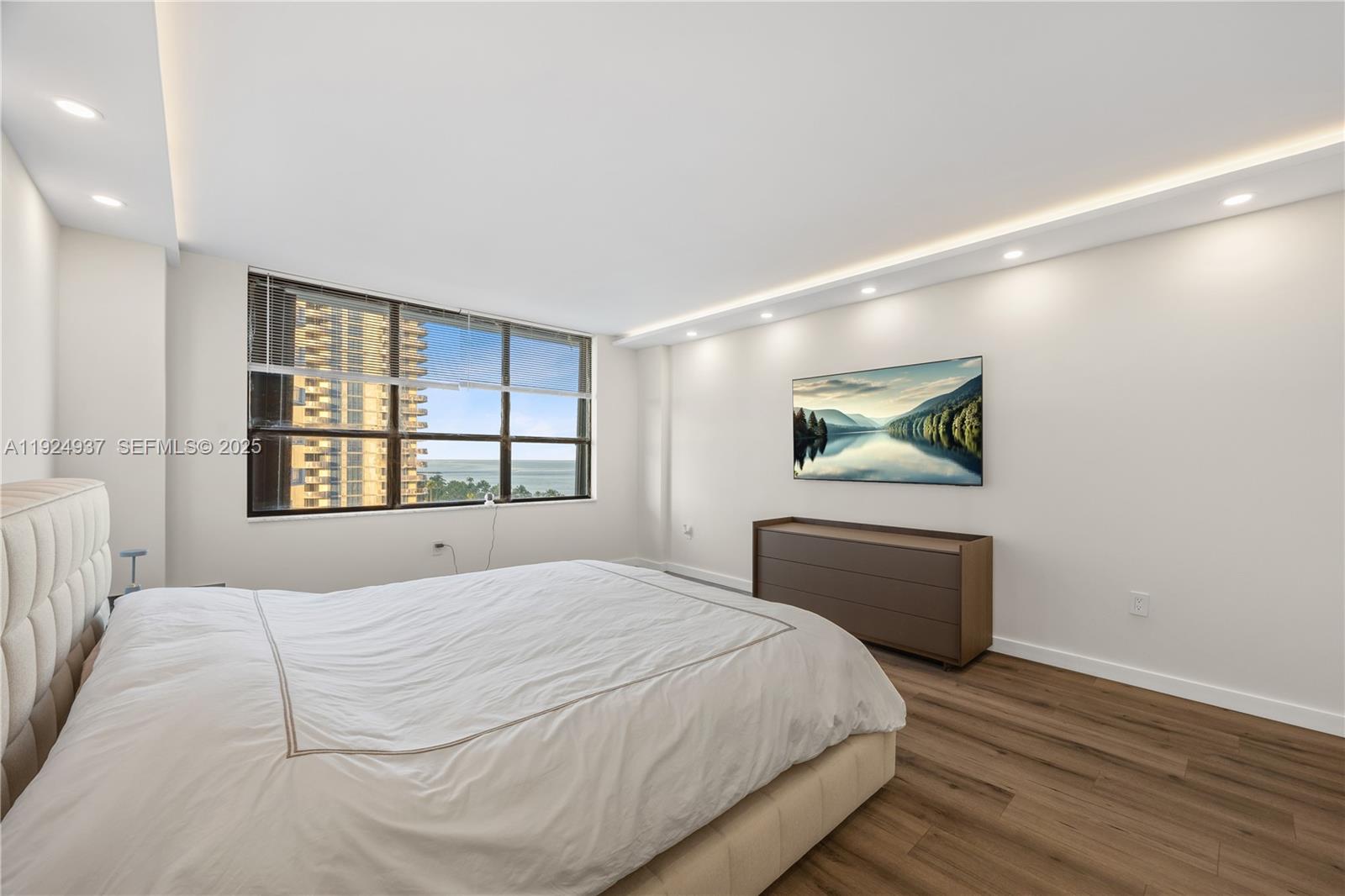 9801 Collins Avenue, Unit 10G Bal Harbour, FL 33154 - Photo 27 of 34 a bedroom with a bed and a window