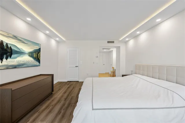 a large white bed in a white room