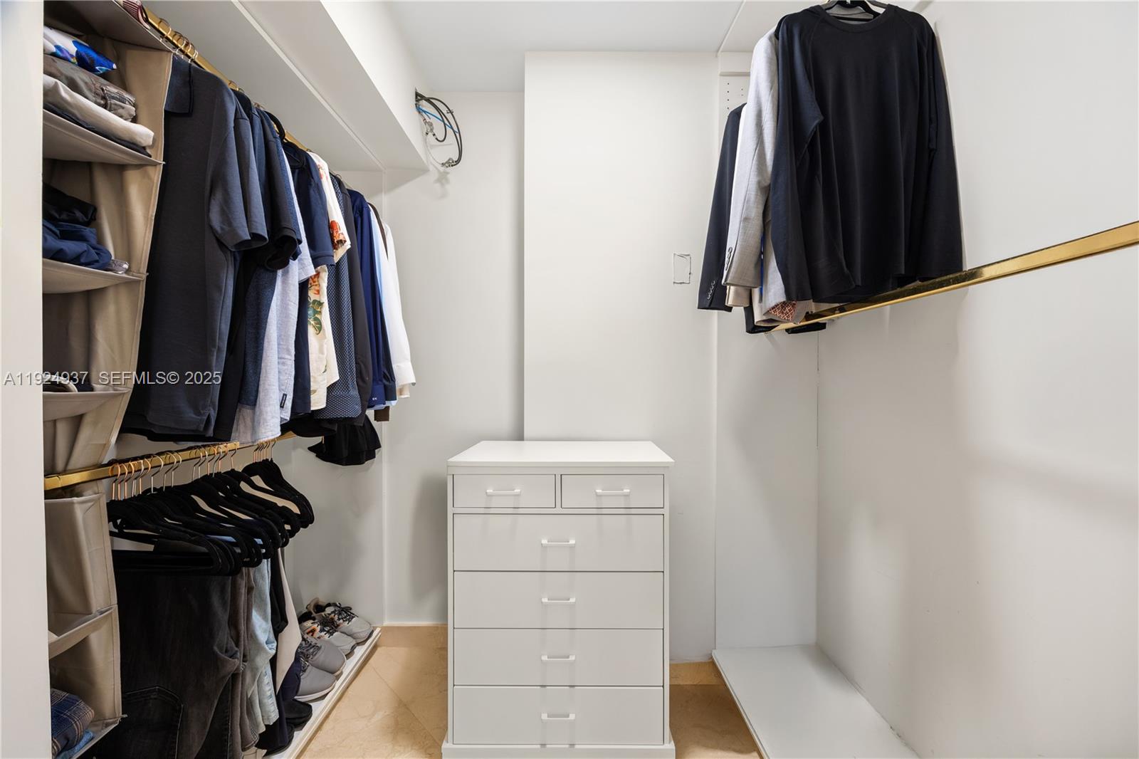 9801 Collins Avenue, Unit 10G Bal Harbour, FL 33154 - Photo 33 of 34 a view of walk in closet with clothes and shoes