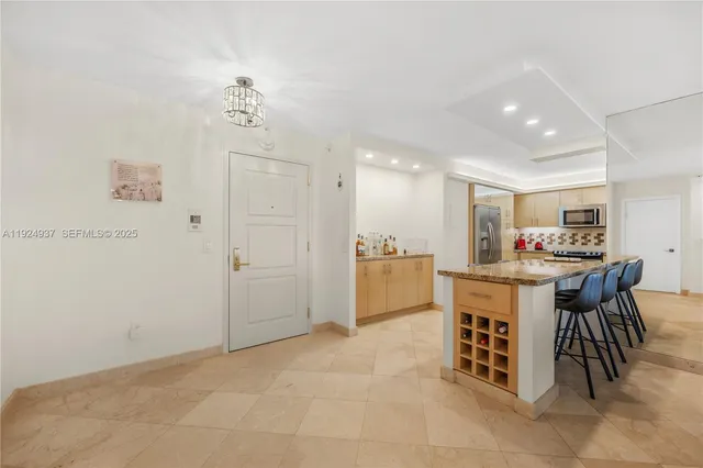 a living room with kitchen island granite countertop furniture and a kitchen view