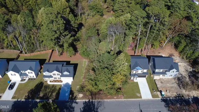 an aerial view of a house with a yard basket ball court and outdoor seating