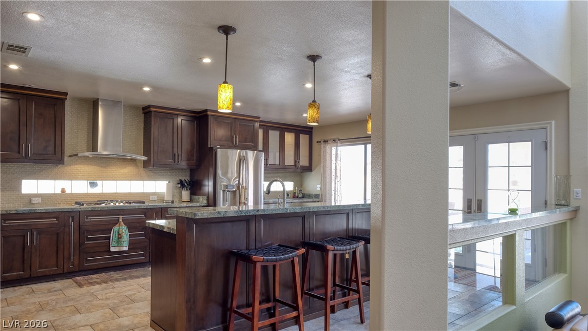 3704 North Campbell Road Las Vegas, NV 89129 - Photo 15 of 38 Culinary creativity thrives in this well-appointed kitchen, featuring rich cabinetry, breakfast bar and luminous stone countertops.