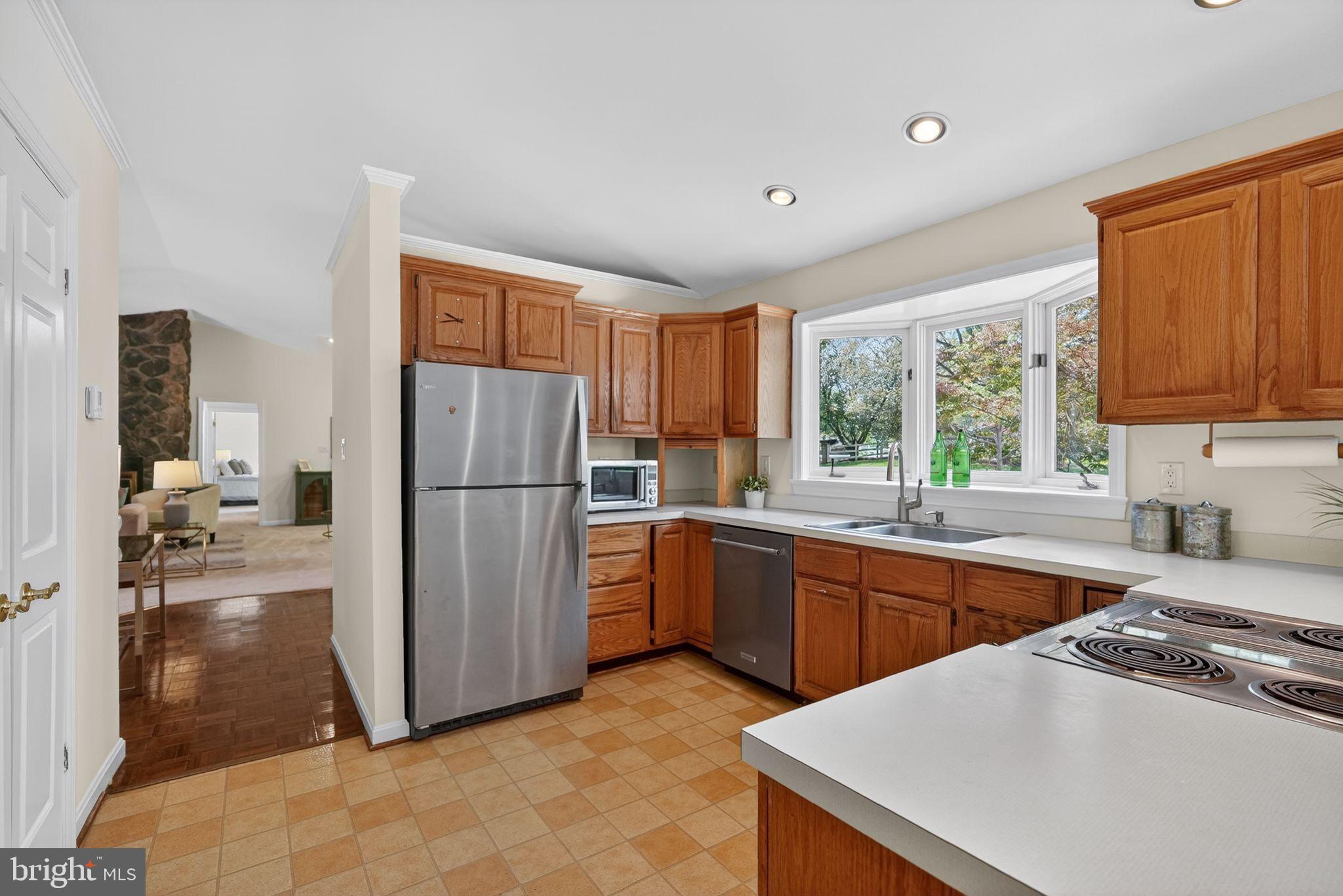 13821 Esworthy Road Darnestown, MD 20874 - Photo 25 of 98 a kitchen with a sink a stove and refrigerator