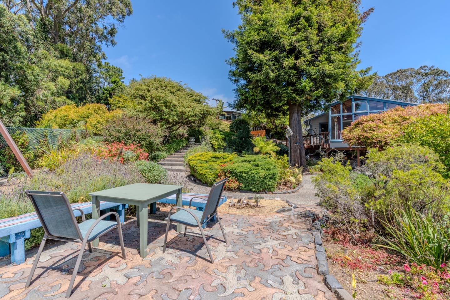 1327 Crespi Drive Pacifica, CA 94044 - Photo 30 of 48 a view of a chairs and table in a backyard