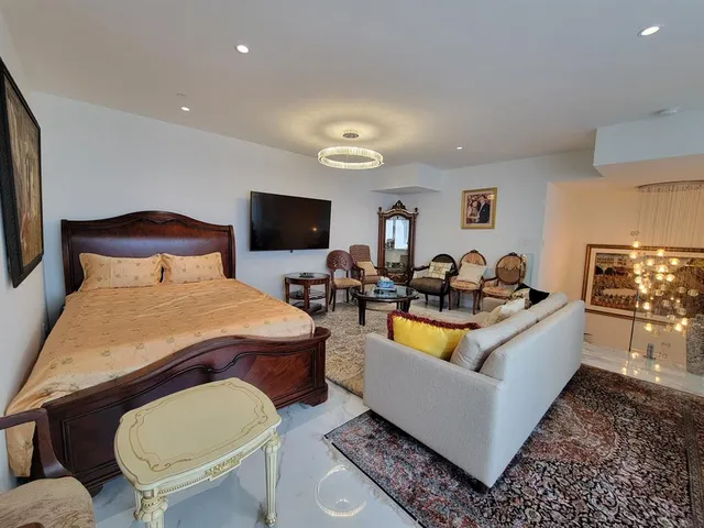 a bed room with furniture and a flat screen tv