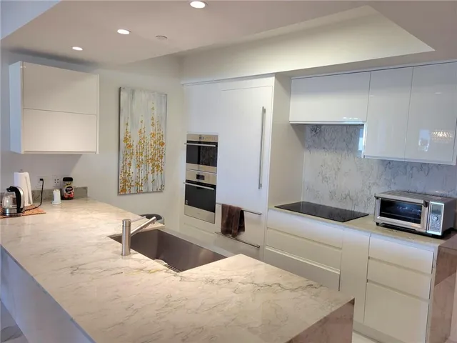 a bedroom with a bed a couch and a large window