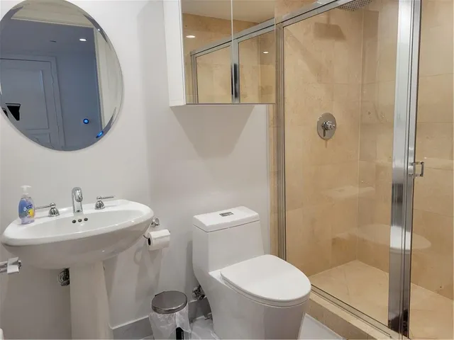 a bathroom with a sink toilet and shower